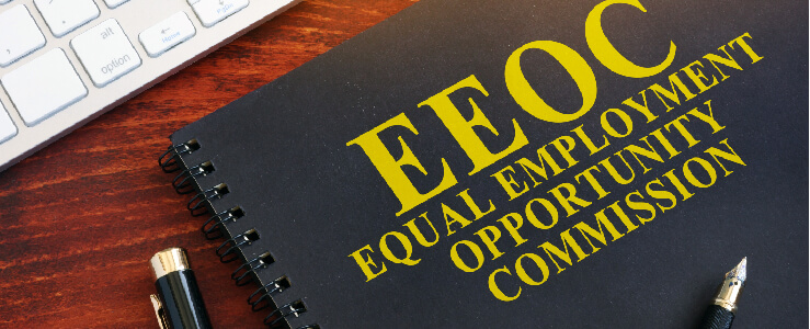 EEOC equal employment opportunity commission book by laptop representation