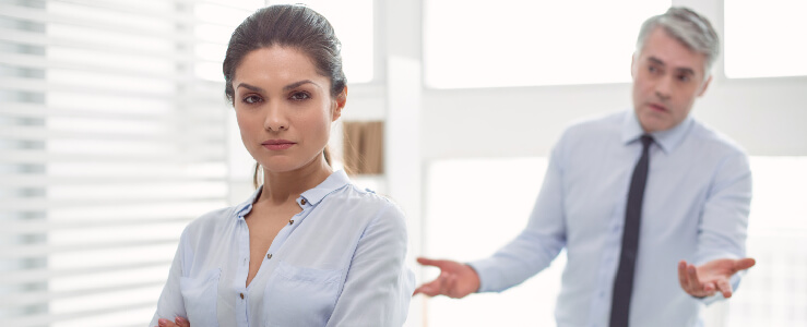 woman looking angry with man behind her annoying coworker