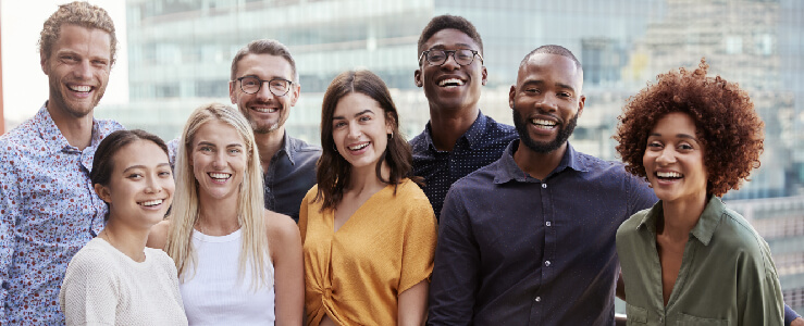 a group of diverse men and woman smiling being mindful at work