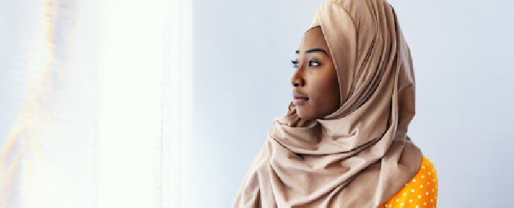 muslim woman looking at reflection religious discrimination