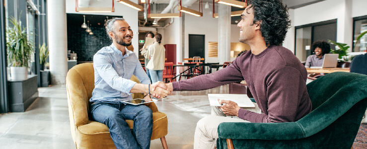 two men shaking hands at an interview unemployed discrimination