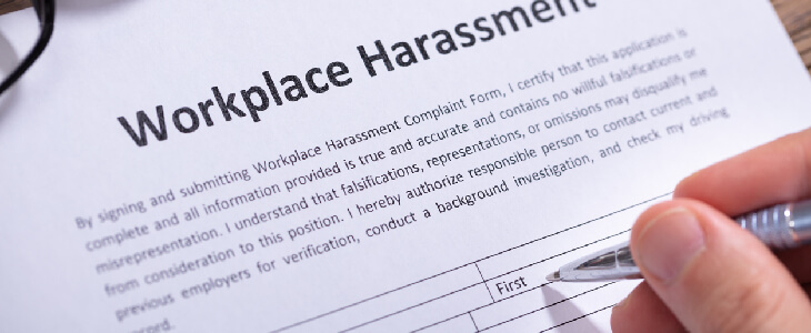 person signing workplace harassment form