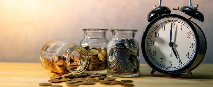 clock next to jars of money