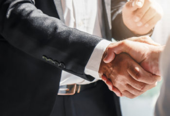 Employment attorney shaking hands with client