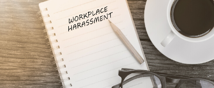 text on paper that reads workplace harassment