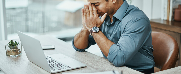 male computer professional feeling stressed from overtime work