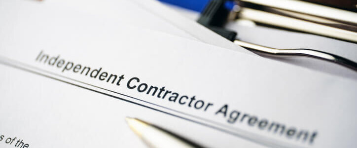Legal document Independent Contractor Agreement on paper close up.
