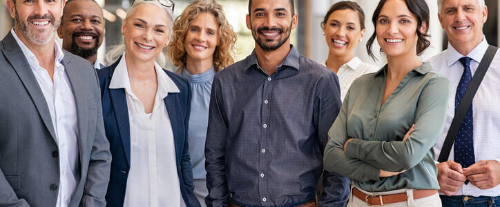 Portrait of successful group of business people at modern office looking at camera. Portrait of happy businessmen and satisfied businesswomen standing as a team. Multiethnic group of people smiling and looking at camera.|Flag and Wall street sign|A Scales in the head with words bias and facts.|A young employer sits alone in the workplace corridor looking unhappy.