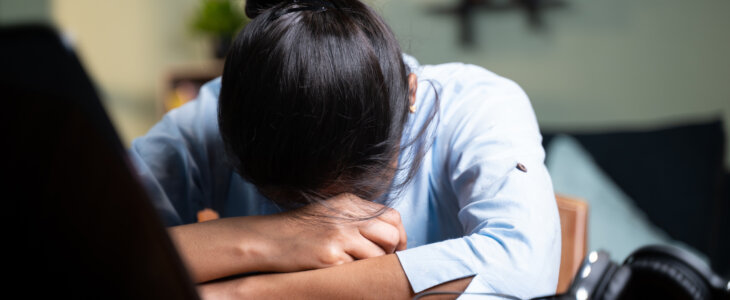 young Business woman sleeping by closing laptop while working, concept of new normal burnout, over or late night work at home during coronavirus covid-19 pandemic.