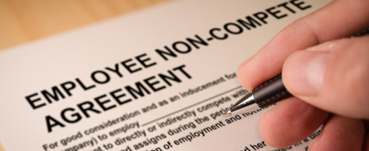 Man signing an employee Non-compete agreement. Selective focus