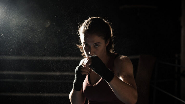 A woman boxer squares up in the ring