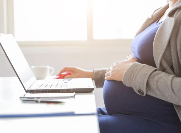 Pregnant woman working on her computer