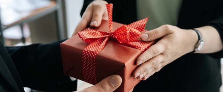 Woman giving gift to man