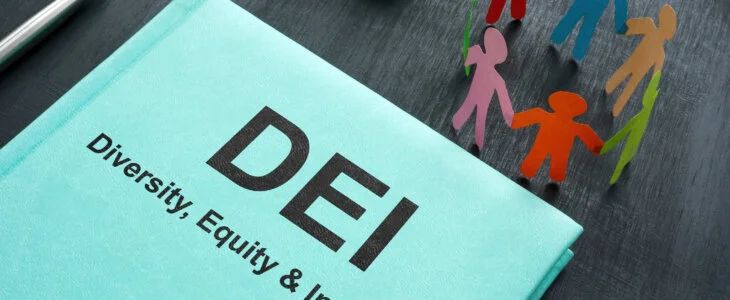 A Book about DEI diversity, equity and inclusion and paper figurines.