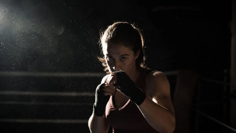 A woman boxer squares up in the ring